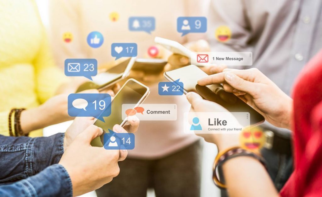 A group of people holding cell phones participating in automated LinkedIn pods.